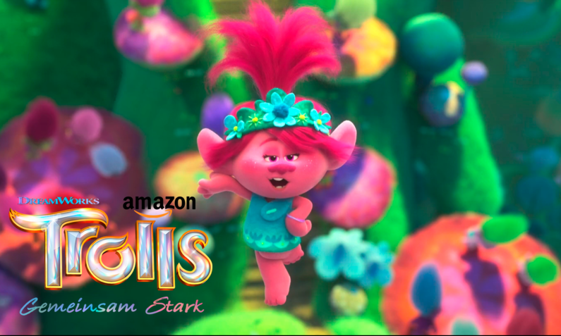 rosa Figur Poppy aus dem Trolls Film mit buntem Hintergrund | © Amazon
