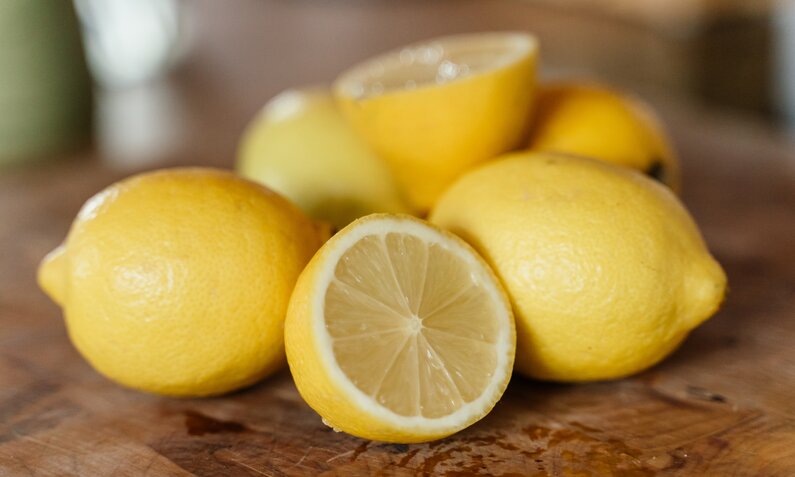 Zitronen auf einem Holztisch | © Getty Images/ Anna Mardo