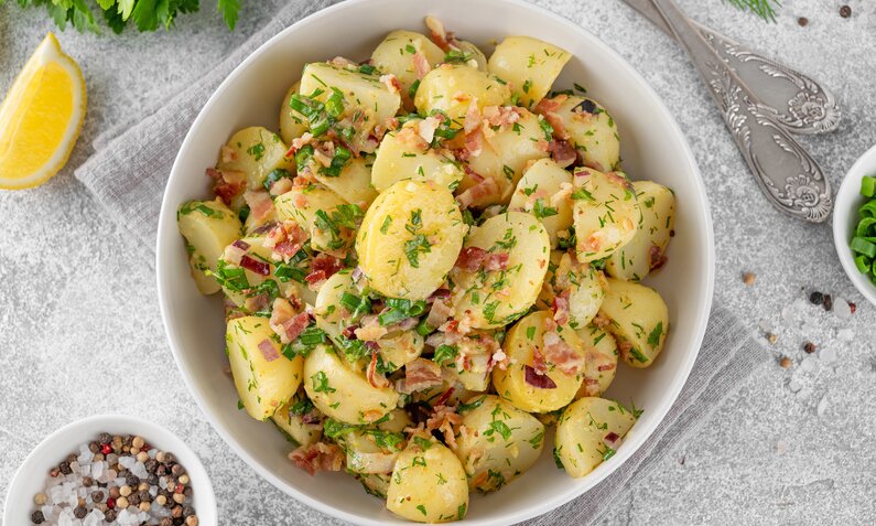 Kartoffelsalat ohne Mayo angerichtet in einer Salatschüssel. | © Adobe Stock / irina2511